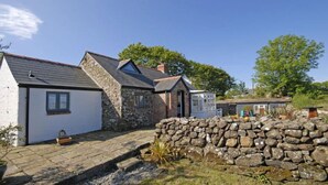 A stone house with a sloped roof, a small attached shed, and a stone wall in the foreground. - Escape To This Hidden Gem & Relax In Tranquility - Beaches & Coastal Path Nearby (st nicholas)
