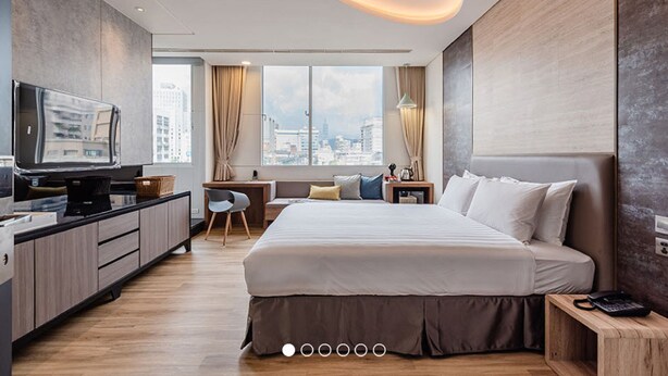 A modern hotel room with a large bed, a desk with a computer, a television, and a city view. - Wow-happy Hotel Taipei (Taipei)