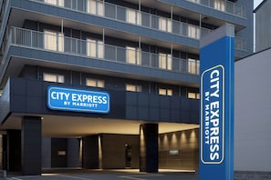 A multi-story building with a sign for 'CITY EXPRESS BY MARRIOTT' indicating a hotel. - City Express By Marriott Osaka Namba South (Osaka)