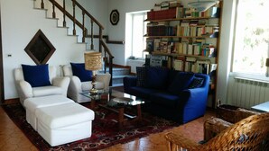 A living room with a staircase, a bookshelf, and a blue sofa. - SPLENDID VIEW OF LAKE COMO bellagio / civenna (Civenna)