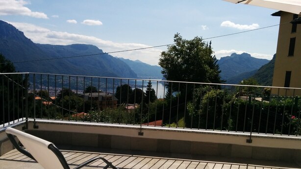 A balcony with a metal railing overlooking a mountainous landscape and a body of water. - SPLENDID VIEW OF LAKE COMO bellagio / civenna (Civenna)