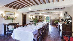 A long dining table set for a meal in a room with wooden beams on the ceiling and a large mirror on the wall. - Villa in San Concordio Di Moriano with 10 bedrooms sleeps 20 (San Concordio Di Moriano)