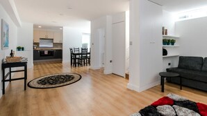 A modern living room with a grey sofa, a black coffee table, and a patterned rug. - Luxury newly renovated 3-bedroom, 2-bathroom mews house in Hampstead London (London)