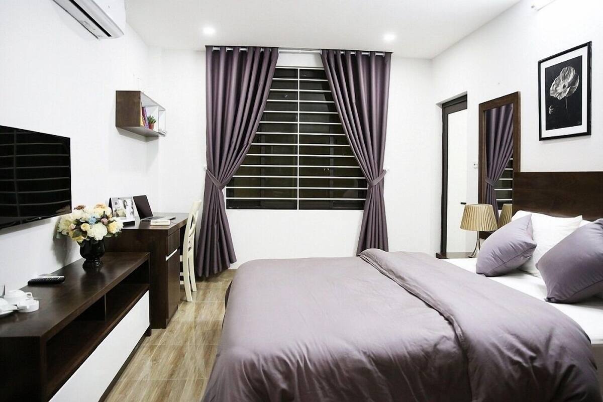 Standard Studio | Desk, laptop workspace, blackout curtains, iron/ironing board