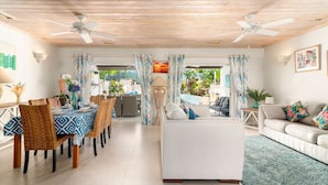 A spacious living area with a dining table, sofas, and a ceiling fan. - 3 Bed Villa with Private Pool, West Coast Barbados (Porters St James)