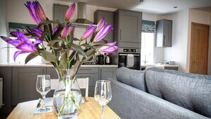 A modern kitchen with grey cabinets, a stainless steel range hood, and a built-in oven. - Cottage sleeps 4 with private hot tub. Edinburgh festival less than 1hr away.  (Kinross)
