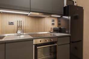 A modern kitchen with stainless steel appliances, a built-in oven, and a microwave.
