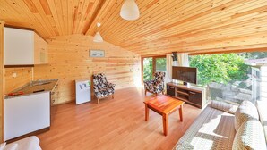 A wooden interior with a kitchen, dining area, and seating. - Villa Dundar Kas Apartments (Kas)