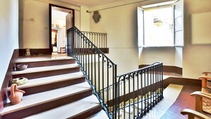 A staircase with a black metal railing leading to an upper floor.