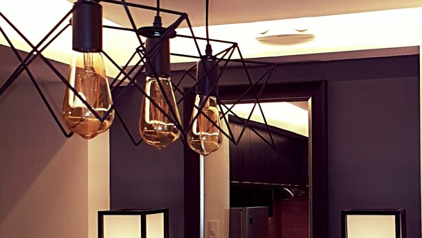 A modern bathroom with geometric pendant lights, a large mirror, and two floor lamps. - BACOLOD CITY CENTER  SLEEK STUDIO DE LUXE (Bacolod)