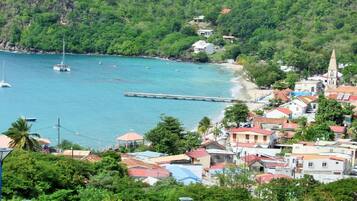 A coastal town with buildings, a pier, and boats on the water.