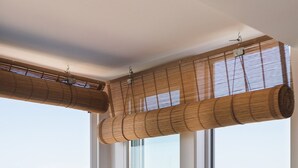 A kitchen with a view of rooftops, three potted plants, and a kettle on the counter. - Romantic Gem in Graça (Lisboa)