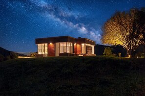 A modern house with large windows, a sloped roof, and a well-lit exterior. - Villa La Betulla, Cerano d'Intelvi, Italy (Cerano d'Intelvi)