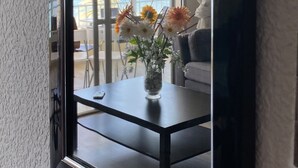 A room with a large window, a dark wooden table, and a vase with flowers. - Beautiful Seafront 3Bed, 2Bath, wifi, first line in Altea (Altea)