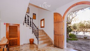 A staircase with a wooden handrail and a wooden door at the bottom. - Villa Sa Cabaneta with pool, tennis court, and views to the Palma Bay (Marratxi)