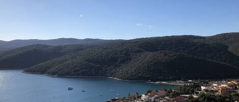 A coastal town with a view of the sea and hills.