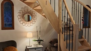 A staircase with wooden railings and a decorative mirror.