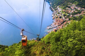 A cable car system with a view of a coastal town below.
