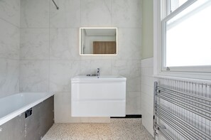 Bathtub, eco-friendly toiletries, hair dryer, towels