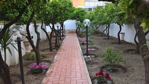 A paved pathway lined with trees and decorative lights, leading through a landscaped garden area. - EUROLUCANIA GUESTHOUSE2 ROOM3 (Bari)