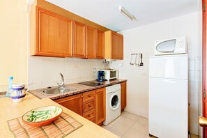 Fridge, microwave, coffee/tea maker, cookware/dishes/utensils