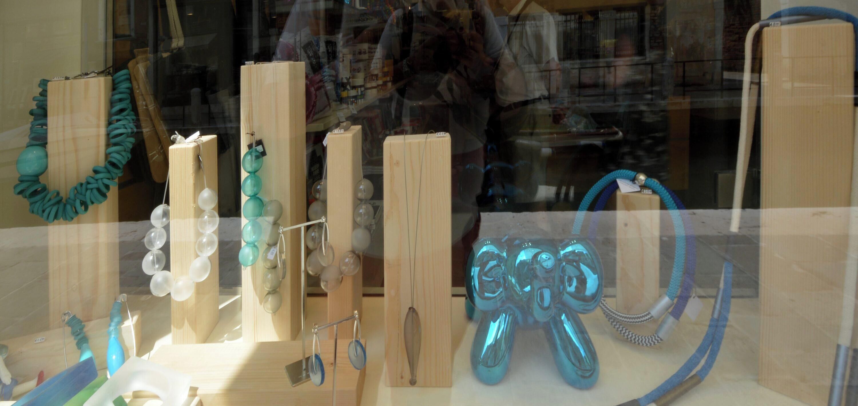A display of various jewelry items, including necklaces, earrings, and a decorative sculpture.