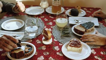 A table set with plates of food, glasses, and a pitcher.