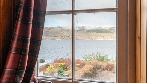 A window with a view of a lake and hills. - Lovely foresters cottage, amazing Loch Ness views, private beach, pets welcome (Inverfarigaig,   Loch Ness)