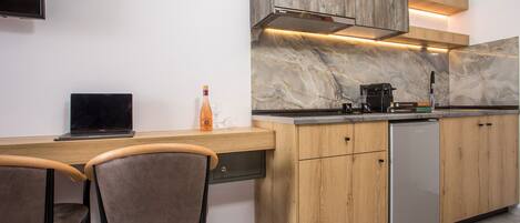 Een moderne keuken met een houten aanrecht, een ingebouwde kookplaat en een koelkast.