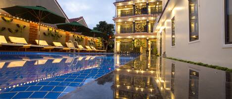 Outdoor pool, open 7 AM to 9 PM, pool umbrellas, pool loungers