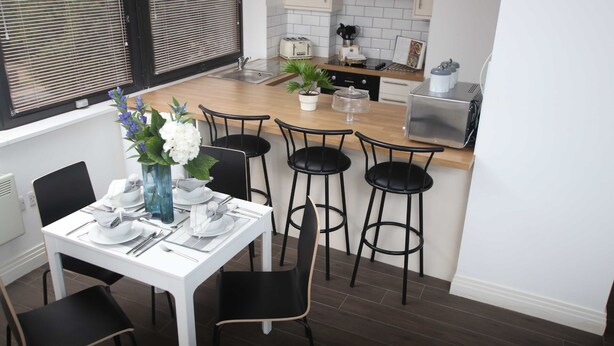 A modern kitchen with a dining area.