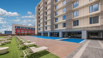 Outdoor pool, open 6:00 AM to 10:00 PM, pool loungers