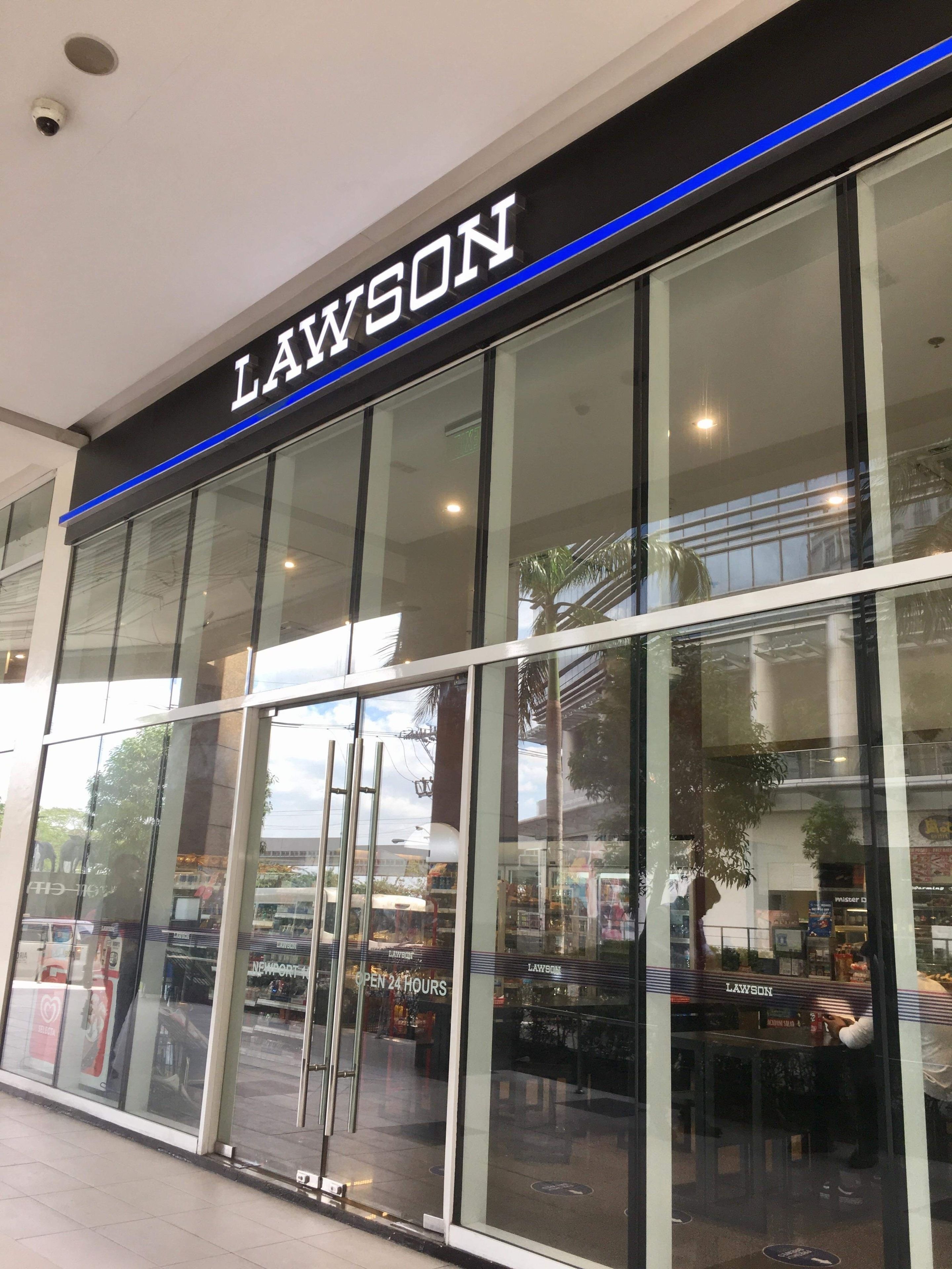 A Lawson store with large glass windows, a black sign with white lettering, and a blue strip above the sign.