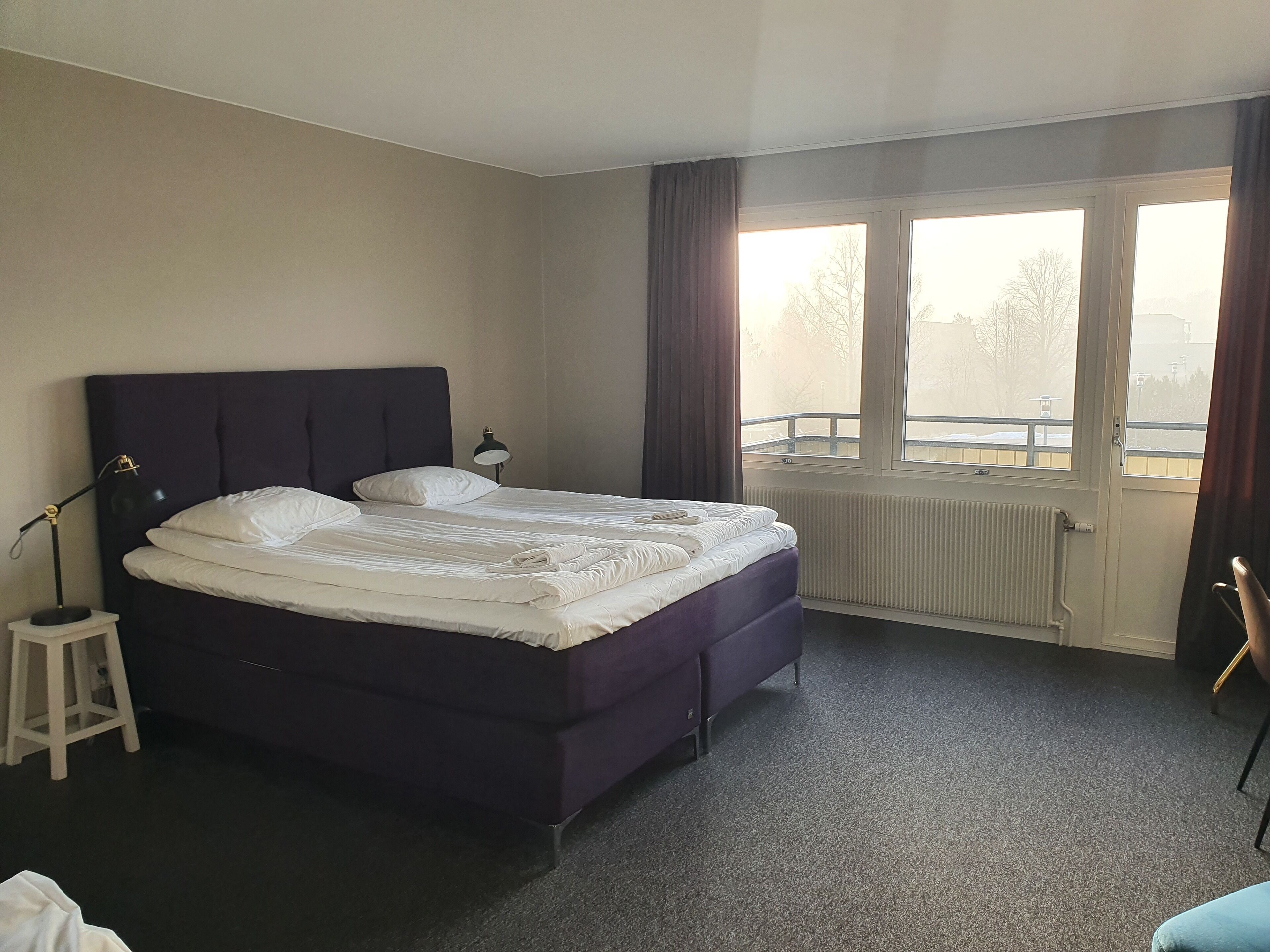 family room (shared bathroom) | desk, blackout curtains, iron/ironing board, rollaway beds