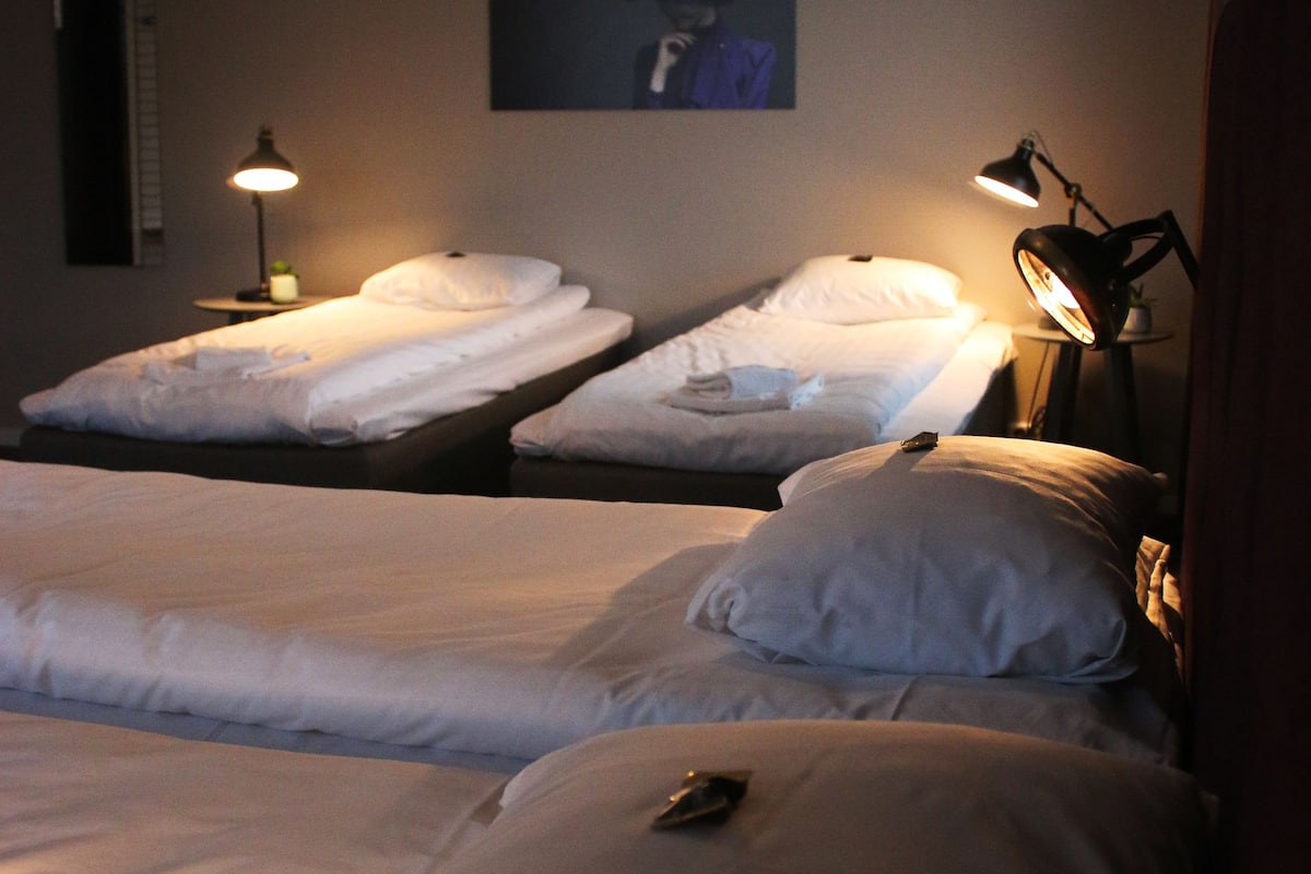 family room (shared bathroom) | desk, blackout curtains, iron/ironing board, rollaway beds