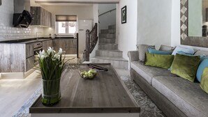 A modern living room with a grey sofa, a wooden coffee table, and a vase of flowers. - New”Deluxe”historic,Canerian style villa,outstanding seaviews,private heatedpool (Tías)