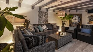 A cozy living room with a sofa, armchairs, a coffee table, and a large wall clock. - New”Deluxe”historic,Canerian style villa,outstanding seaviews,private heatedpool (Tías)
