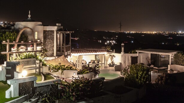 A rooftop terrace with a pool, outdoor seating, and a view of the city at night. - New”Deluxe”historic,Canerian style villa,outstanding seaviews,private heatedpool (Tías)