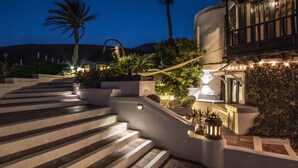 A well-lit outdoor staircase leading to a building with a stone wall and a balcony. - New”Deluxe”historic,Canerian style villa,outstanding seaviews,private heatedpool (Tías)