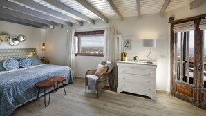 A bedroom with a large bed, a dresser, a chair, and a window with a view. - New”Deluxe”historic,Canerian style villa,outstanding seaviews,private heatedpool (Tías)
