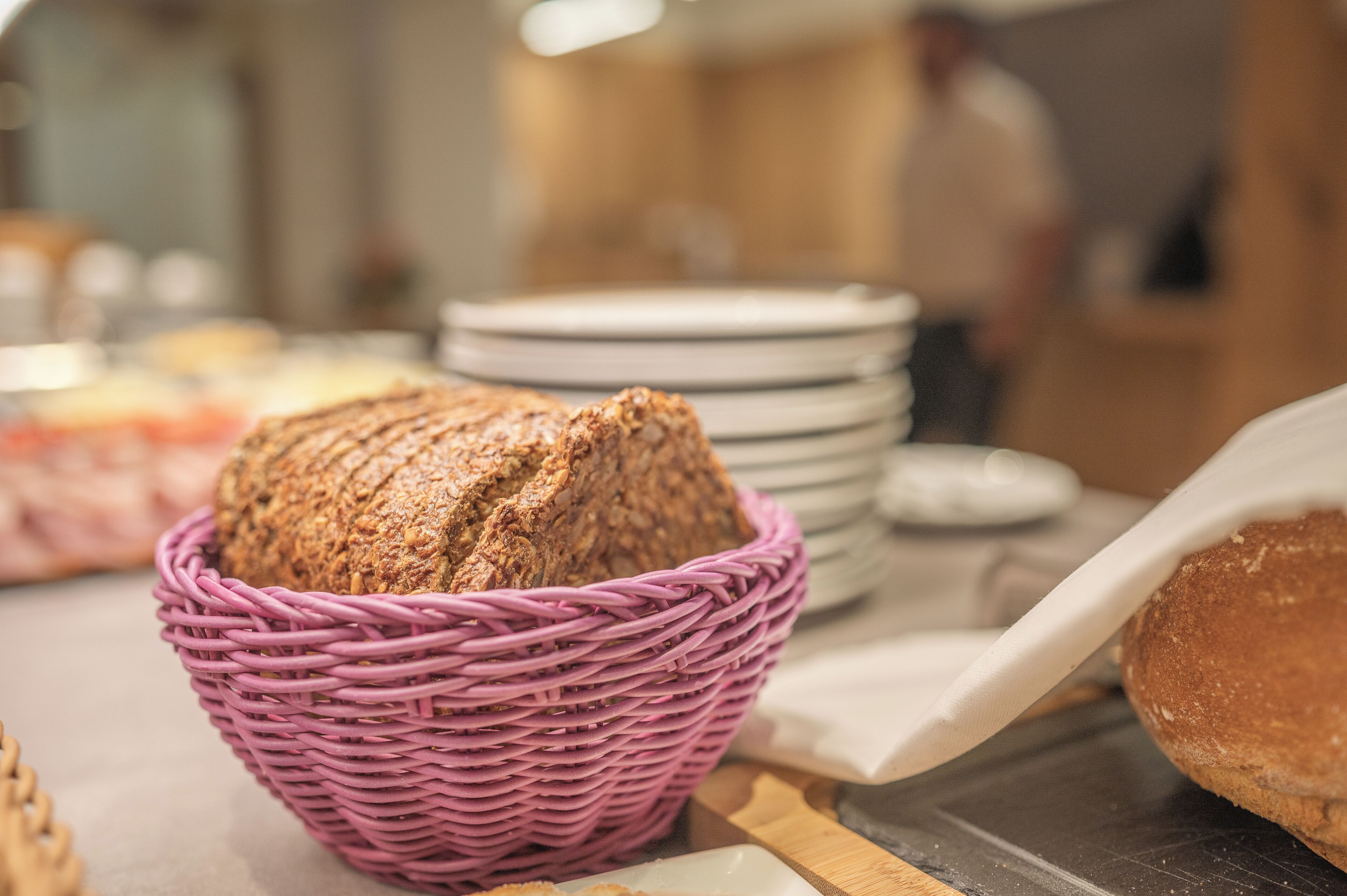 A wicker basket filled with sliced bread on a counter.