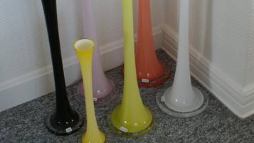 A collection of colorful vases arranged against a wall.
