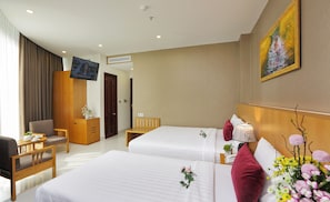Suite Triple Room | Minibar, in-room safe, desk, blackout drapes