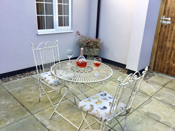 Enjoy dining or socializing on the patio with a round table and comfortable chairs.