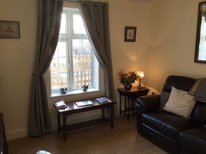 Relax in this inviting living room with a sofa, armchair, and coffee table.