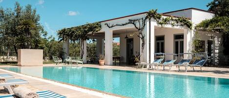 An infinity pool, pool loungers