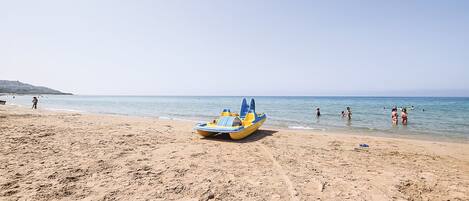 On the beach, sun-loungers