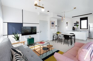 Two Bedroom Penthouse with Balcony | Living room | 50-inch flat-screen TV with cable channels, Smart TV