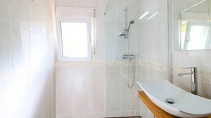 A modern bathroom with a glass-enclosed shower, a white sink, and a large mirror. - Villa with panoramic views and swimming pool Marquesa JM 4 people (Denia)