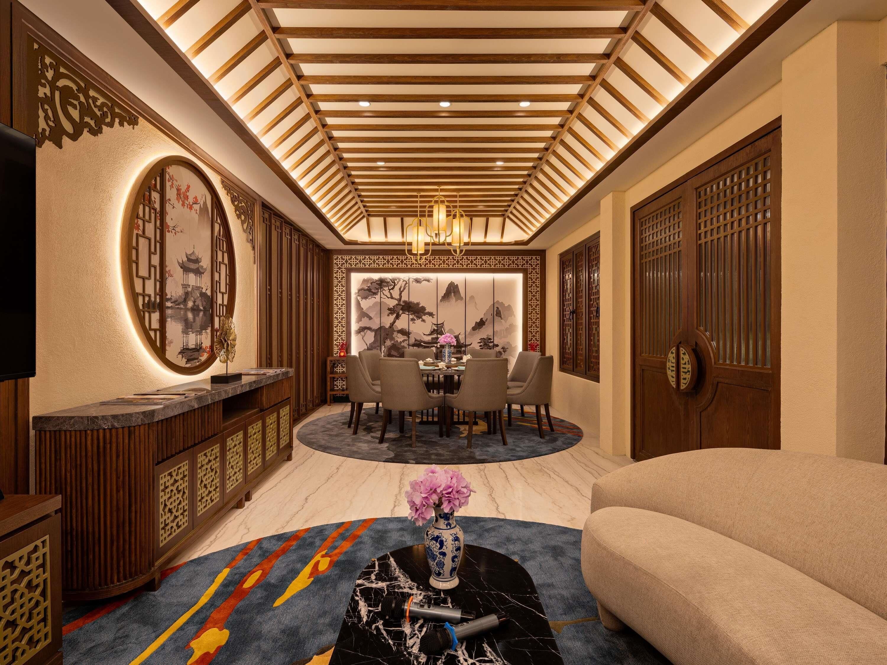 A traditional interior with a dining area, sofa, and decorative elements.